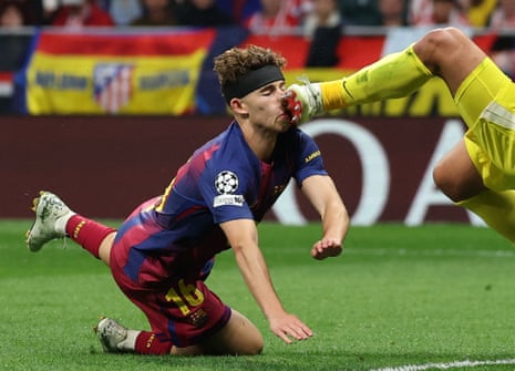 Barcelona’s Fermin Lopez misses a chance score before colliding with Atletico Madrid’s keeper Juan Musso.