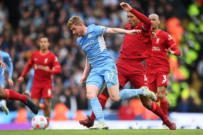 Kevin De Bruyne of Manchester City is tripped by Virgil van Dijk of Liverpool.