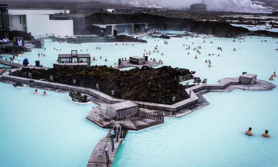 People bathing in The Blue Lagoon, a geothermal bath resort in Iceland