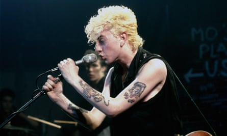 The Stray Cats on stage at the Markthalle in Hamburg in 1981, with Brian Setzer singing and Slim Jim Phantom in the background.