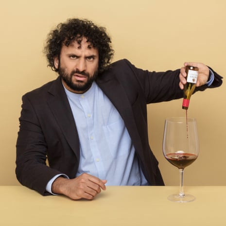 Nish Kumar pouring a glass of red wine