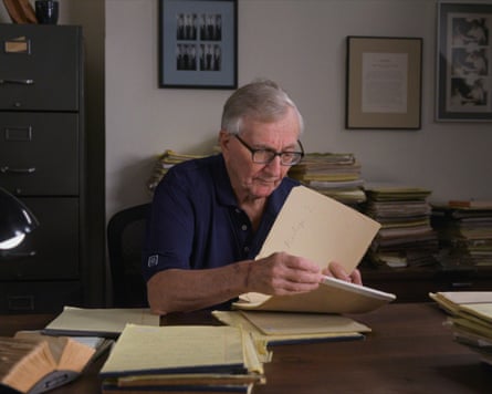 Seymour Hersh at his desk reading papers.