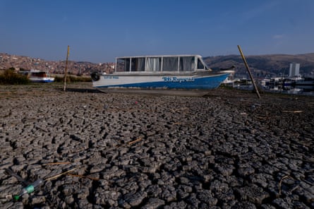 A boat sits in the river mud.