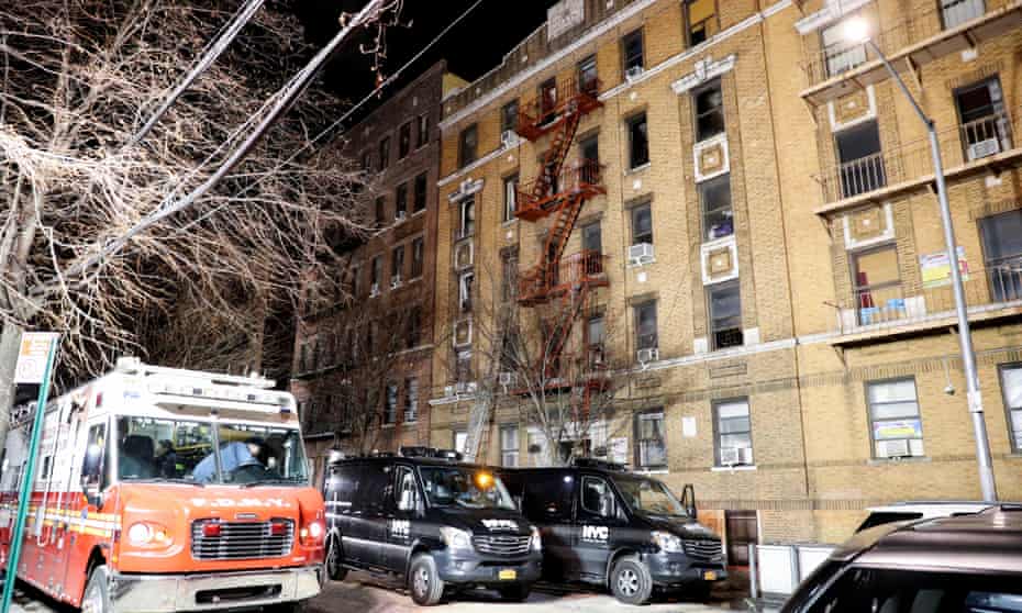 Emergency service vehicles attend the site of an apartment fire in Bronx, New York, on Friday.