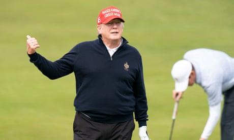 Trump wearing red Maga cap gestures with golfer bending behind on green