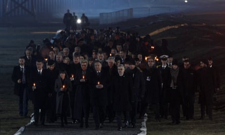 Attendees arrive to put candles at a memorial site at the Auschwitz camp.