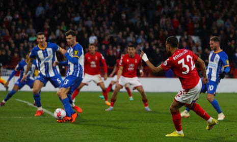 Nottingham Forest's Renan Lodi (right) shoots the ball that touches Brighton's Pascal Gross (no 13) and goes in the net for own goal and put Nottingham Forest level.