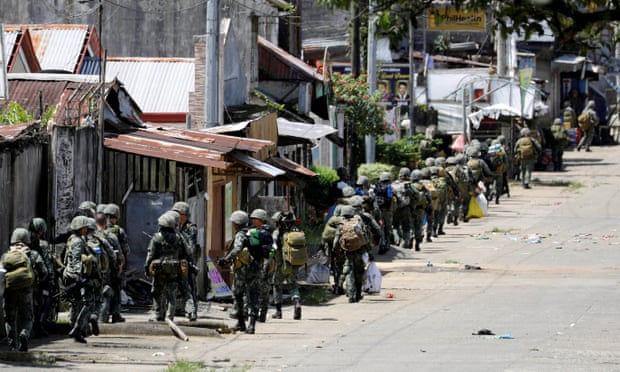 Philippine Marines advance their positions as more soldiers reinforce to fight the Maute group in Marawi City in southern Philippines.