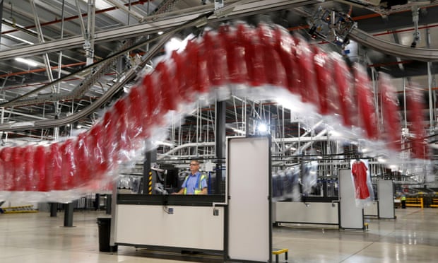 A worker watches an automated garment transfer system at John Lewis’s distribution centre in Milton Keynes.