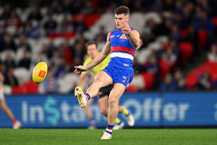 Josh Dunkley kicks the ball during an AFL game