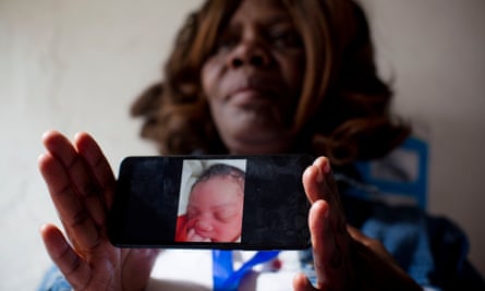 Midwife Pamela Dochieng holds up her phone to show a photo of a baby that was delivered and then abandoned at a clinic in Kibera.