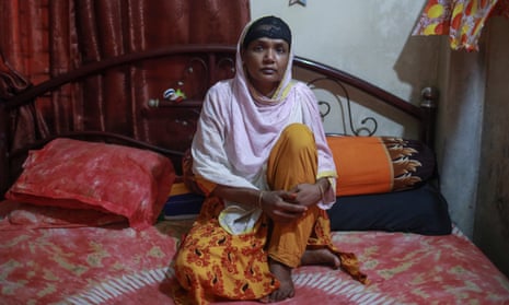Akhi Akter, 30, at home in Ashulia, says she hasn’t been paid for two months she worked before she fell ill with Covid symptoms.