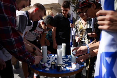 People light candles in memory of the victims on the one-month anniversary of the attack by Hamas on 7 October.