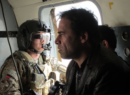 Agence France-Presse photographer Shah Marai sits in a helicopter with a member of the International Security Assistance Force while on assignment in Afghanistan in 2013.