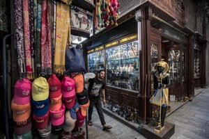 A man walks past a shop selling replicas of ancient Egyptian statuettes, figurines, and canopic jars at the Khan el-Khalili bazaar area in Cairo