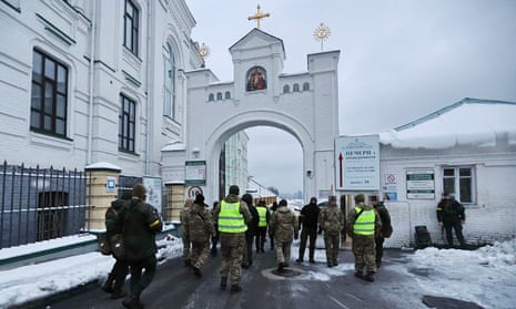 Ukrainian law enforcement officers stand next to the entrance of the Kyiv Pechersk Lavra monastery  in Kyiv