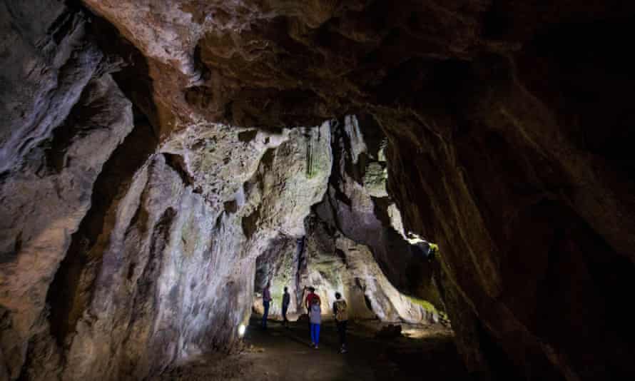A local guide and visitors walk in the Bacho Kiro cave, northern Bulgaria.