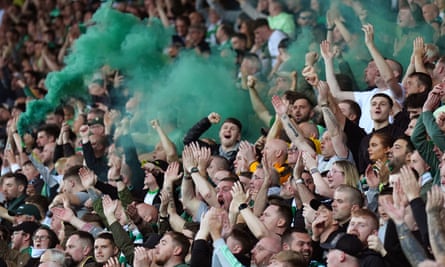 Celtic fans set off green smoke bombs in the stands
