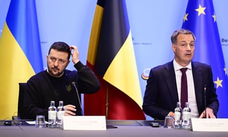 Zelenskiy and De Croo with the flags of Ukraine, Belgium and the EU in the background