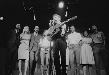 Bob Dylan during a performance at the Newport Folk Festival in 1963. Those visible behind him are (from left) Peter Yarrow, Mary Travers and Paul Stookey (of Peter, Paul and Mary), Joan Baez (partially obscured), Charles Neblett, Rutha Mae Harris and Pete Seeger.