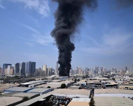 A plume of smoke rises from a warehouse Sharjah city in the UAE following Iranian strikes.