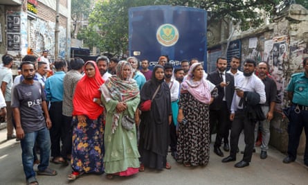 Relatives of those arrested in connection with the violence wait outside the magistrates court in Dhaka.