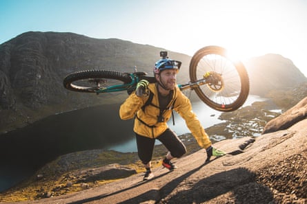 Danny MacAskill carrying his bike