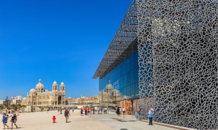 Tourists strolling on the promenade next to the MuCEM,