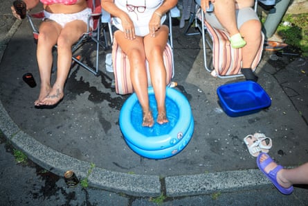 People sit with their feet in cold water in Burnley, Lancashire during last year’s UK heatwave.