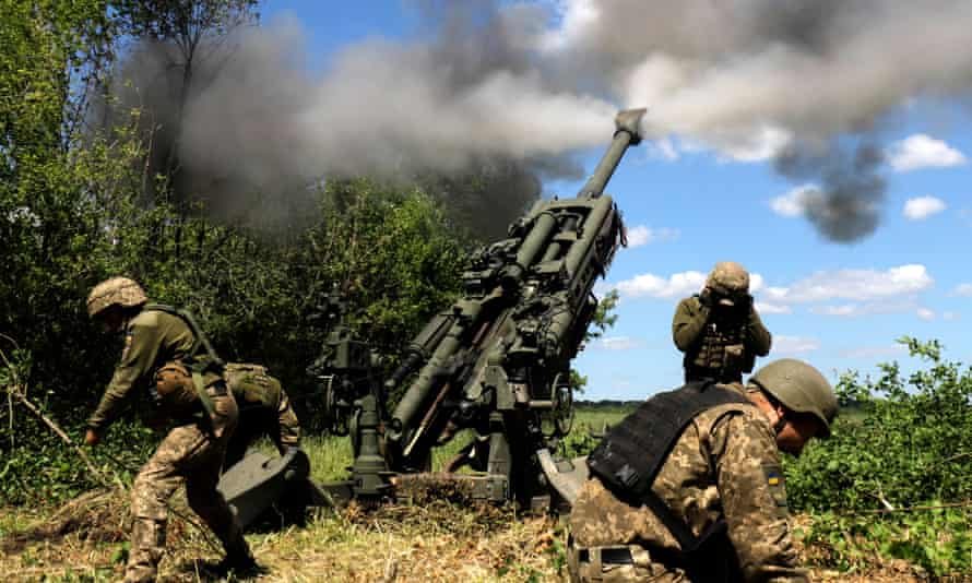 Ukrainian service members fire a M777 howitzer at a point on the frontline in Donetsk on Monday.