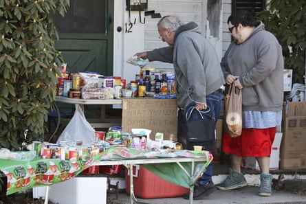 Residents select items on a community table filled with groceries for those in need, in Derry, New Hampshire.