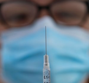 A nurse prepares a Covid vaccine in Los Angeles on Saturday.