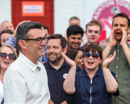 Burnham side-on with cheering supporters in the background