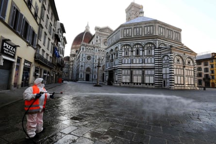 A worker disinfects the popular tourist destination Piazza del Duomo in Florence.