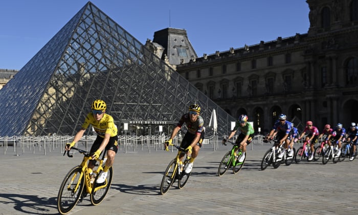 Jonas Vingegaard, wearing the overall leader’s yellow jersey, passes the Louvre Museum