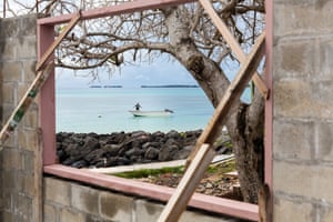 A child plays on a boat in the Funafuti lagoon
