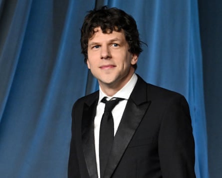 man in black suit smiles