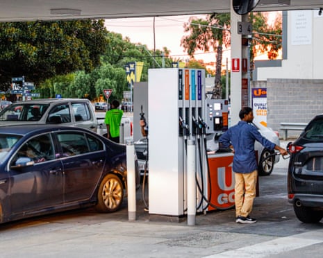 People putting petrol in their vehicles in Melbourne, Australia, amid elevated prices and growing shortages