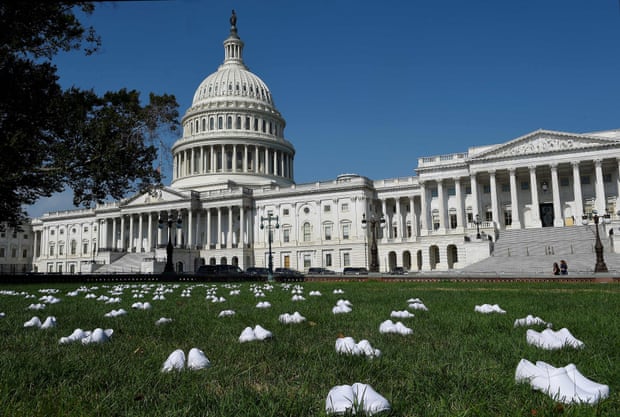 National Nurses United (NNU) display 164 white clogs shoes outside the US Capitol to honor the more than 160 nurses who have lost their lives from Covid-19 in the US.