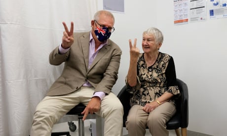 Australian prime minister Scott Morrison gives the V for victory sign with Jane Malysiak, 84, who was Australia’s first recipient of a Covid-19 vaccination
