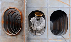 A worker polishes steel plate at a dockyard in Wuhu, Anhui , China