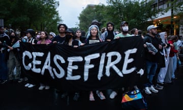 students hold a sign that says "ceasefire"