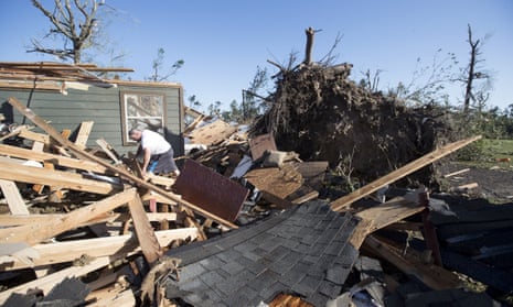 David Maynard sifts through the rubble searching for his wallet in Onalaska, Texas, on Thursday after a tornado destroyed his home the night before.