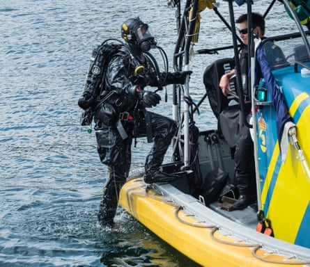 A Swedish coastguard diver exits the water
