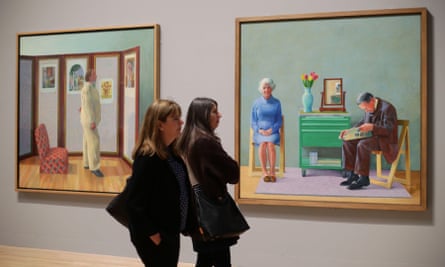 Visitors standing next to Looking at Pictures on a Screen (left) and My Parents in a David Hockney exhibition at Tate Britain in 2017.