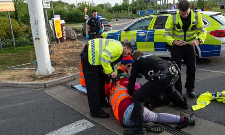 An arrest is made as activists from Just Stop Oil target a Shell Petrol station on the M25 motorway on April 28, 2022.