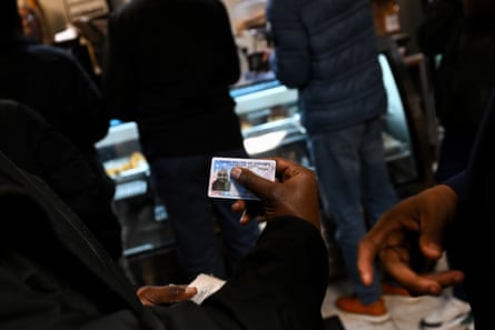 a man holds a passport card