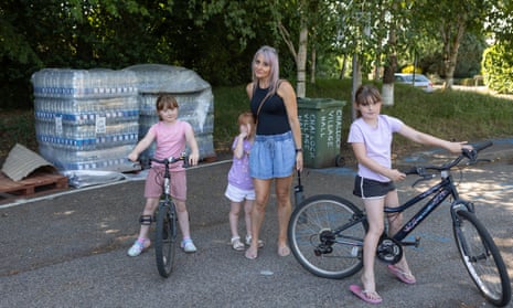 Hayley Leavy and her children and the stockpiles of bottled water