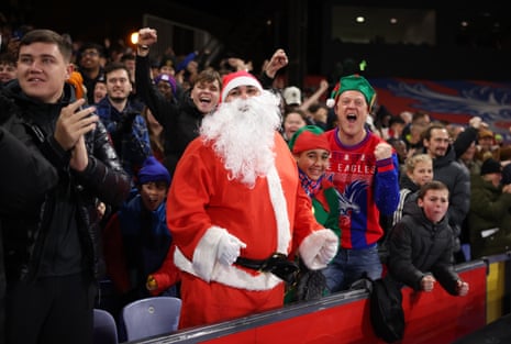 Fans of Crystal Palace, wearing Christmas-themed costumes, celebrate after Ismaïla Sarr of Crystal Palace scores his team’s equalising goal against Arsenal at Selhurst Park
