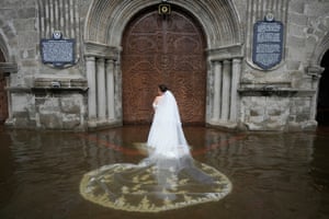Bride Jamaica Aguilar prepares to enter the flooded Barasoain church for her wedding in Malolos